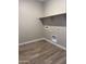Neat laundry room with washer/dryer hookups and wood flooring at 18354 W Patrick Ln, Surprise, AZ 85387