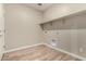 The laundry room with wood-look floors and shelving space at 18354 W Patrick Ln, Surprise, AZ 85387