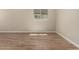 Open-concept living room featuring wood-look tile floors, neutral walls, and recessed lighting at 18354 W Patrick Ln, Surprise, AZ 85387
