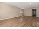 Open-concept living room featuring wood-look tile floors, neutral walls, and recessed lighting at 18354 W Patrick Ln, Surprise, AZ 85387