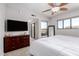 Bedroom with exterior views, light walls, dresser and large television at 20660 N 40Th St # 2124, Phoenix, AZ 85050
