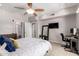 Bright bedroom featuring a ceiling fan, desk, mirror and modern decor at 20660 N 40Th St # 2124, Phoenix, AZ 85050