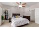 Bright bedroom featuring a ceiling fan, white walls and carpet, and light wood furniture at 20660 N 40Th St # 2124, Phoenix, AZ 85050