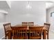 Dining room with wooden table and chairs, bright overhead lighting, and neutral walls at 20660 N 40Th St # 2124, Phoenix, AZ 85050