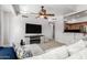 Spacious living room featuring a large TV, neutral walls, and seamless access to the kitchen at 20660 N 40Th St # 2124, Phoenix, AZ 85050