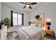 Modern bedroom with neutral tones, a cozy bed, natural wood accents, and soft lighting for a relaxing atmosphere at 21833 N 34Th Ave, Phoenix, AZ 85027