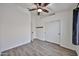 Bright bedroom featuring wood-look floors and a closet with sliding doors at 21833 N 34Th Ave, Phoenix, AZ 85027