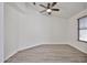 Bedroom with new flooring, neutral walls, ceiling fan, and a window at 21833 N 34Th Ave, Phoenix, AZ 85027