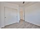 Bright bedroom with wood-look flooring, closet and bathroom access, and natural lighting at 21833 N 34Th Ave, Phoenix, AZ 85027
