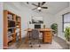 Bright home office featuring a wooden desk, shelving, and modern decor for a productive workspace at 21833 N 34Th Ave, Phoenix, AZ 85027
