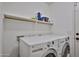 Functional laundry room with modern washer and dryer and shelving at 21833 N 34Th Ave, Phoenix, AZ 85027