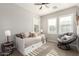 Inviting bedroom featuring neutral tones, window shutters, and a comfortable daybed and papasan chair at 2371 W Whisper Rock Trl, Phoenix, AZ 85085