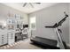 Bedroom with an organized desk area, shelves, computer, and a ProForm treadmill at 2371 W Whisper Rock Trl, Phoenix, AZ 85085