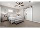 Bright main bedroom featuring a barn door to the main bathroom and an upholstered bench at 2371 W Whisper Rock Trl, Phoenix, AZ 85085