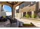 Inviting covered patio with stylish seating, modern decor, and a view of the backyard landscaping at 2371 W Whisper Rock Trl, Phoenix, AZ 85085