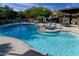 Community pool area with lounge chairs and shade umbrellas at 2371 W Whisper Rock Trl, Phoenix, AZ 85085