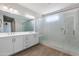 Bathroom with double sink vanity, large mirror, and glass shower enclosure at 24533 N 19Th Ter, Phoenix, AZ 85024