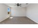 A bright bedroom features neutral carpet and ceiling fan with lights at 24533 N 19Th Ter, Phoenix, AZ 85024