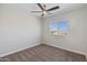 Bedroom featuring neutral walls, neutral carpet, a ceiling fan, and a window with neighborhood views at 24533 N 19Th Ter, Phoenix, AZ 85024