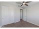 Bedroom featuring neutral walls, neutral carpet, closet, and a ceiling fan at 24533 N 19Th Ter, Phoenix, AZ 85024