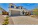 Charming home featuring a paved driveway, an attached two-car garage, and desert landscaping at 24533 N 19Th Ter, Phoenix, AZ 85024