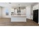 Stylish kitchen with white cabinetry, stainless steel appliances, and a center island with a sink at 24533 N 19Th Ter, Phoenix, AZ 85024