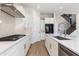 Open kitchen with stainless appliances, central island with sink, and ample storage space at 24533 N 19Th Ter, Phoenix, AZ 85024