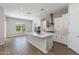 Bright kitchen featuring a center island, stainless steel appliances, and white cabinets at 24533 N 19Th Ter, Phoenix, AZ 85024