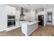 Beautiful open kitchen featuring stainless appliances, white cabinets, and a spacious center island at 24533 N 19Th Ter, Phoenix, AZ 85024