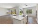 Modern kitchen with a center island featuring a stainless steel sink, tile floors, and stainless steel appliances at 24533 N 19Th Ter, Phoenix, AZ 85024