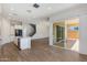 Open living space with wood-style tile flooring, modern kitchen, and access to the backyard at 24533 N 19Th Ter, Phoenix, AZ 85024