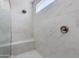 Modern tiled shower with a built-in bench and glass door at 24533 N 19Th Ter, Phoenix, AZ 85024