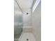 Modern tiled shower with a built-in bench, glass door, and overhead light at 24533 N 19Th Ter, Phoenix, AZ 85024