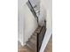 Carpeted staircase with modern black metal railing and white walls at 24533 N 19Th Ter, Phoenix, AZ 85024