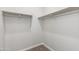 An empty walk-in closet with a shelf and carpeted floor at 24533 N 19Th Ter, Phoenix, AZ 85024