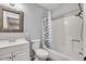 Cozy bathroom with a shower-tub combo, patterned shower curtain, and a vanity with a mirror at 25 N Cottonwood St # 47, Chandler, AZ 85225