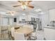 Well-lit dining area showcasing a modern ceiling fan, white cabinetry, and stainless-steel appliances at 25 N Cottonwood St # 47, Chandler, AZ 85225