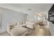 Spacious living room with modern laminate flooring and an open floor plan that connects to the dining area at 25 N Cottonwood St # 47, Chandler, AZ 85225