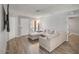 Open-concept living room features laminate flooring, neutral paint, and views to the exterior front yard at 25 N Cottonwood St # 47, Chandler, AZ 85225