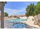Community pool and spa area with lounge chairs and shade under a clear, blue sky at 25 N Cottonwood St # 47, Chandler, AZ 85225