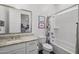Bathroom featuring a granite countertop, white cabinets, white tiled shower, and colorful shower curtain at 2514 E Pleasant Ln, Phoenix, AZ 85042