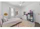 Bedroom featuring carpet, white walls, a ceiling fan, a light pink bedspread and colorful rug at 2514 E Pleasant Ln, Phoenix, AZ 85042