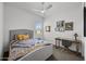 Bedroom featuring carpet, a ceiling fan, and a desk with a wooden frame and gray desk chair at 2514 E Pleasant Ln, Phoenix, AZ 85042