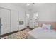 Bedroom featuring carpet, white walls, a ceiling fan, a light pink bedspread, a colorful rug and attached bathroom at 2514 E Pleasant Ln, Phoenix, AZ 85042