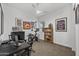 Bedroom features carpet, a ceiling fan, a dark desk, and various movie themed artwork adorning the walls at 2514 E Pleasant Ln, Phoenix, AZ 85042