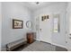 Cozy foyer featuring a bench, wood floors, and natural light, offering a welcoming entrance at 2514 E Pleasant Ln, Phoenix, AZ 85042
