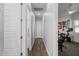 Long hallway with wood floors, white doors, and light blue walls leading into a room with exercise equipment at 2514 E Pleasant Ln, Phoenix, AZ 85042