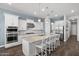 Contemporary kitchen with white cabinetry, stainless steel appliances, and a large island with seating, perfect for entertaining at 2514 E Pleasant Ln, Phoenix, AZ 85042