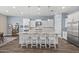 Modern kitchen with white cabinets, stainless steel appliances, large island with seating, and stylish pendant lighting at 2514 E Pleasant Ln, Phoenix, AZ 85042