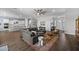 Spacious living room featuring hardwood floors, a comfortable sectional sofa, and an inviting open floor plan at 2514 E Pleasant Ln, Phoenix, AZ 85042